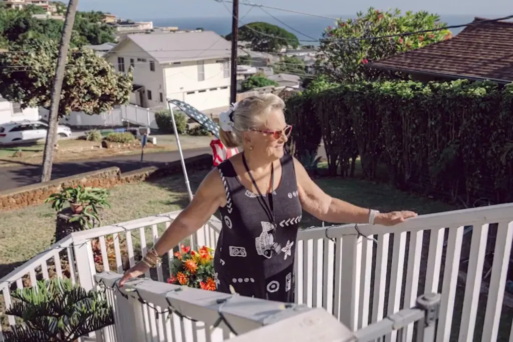 Sandra May, 83, stands outside her Honolulu home. May sued the city over a $590,000 fine she received after a technical glitch on an online rental platform accidentally listed her property for short-term stays.