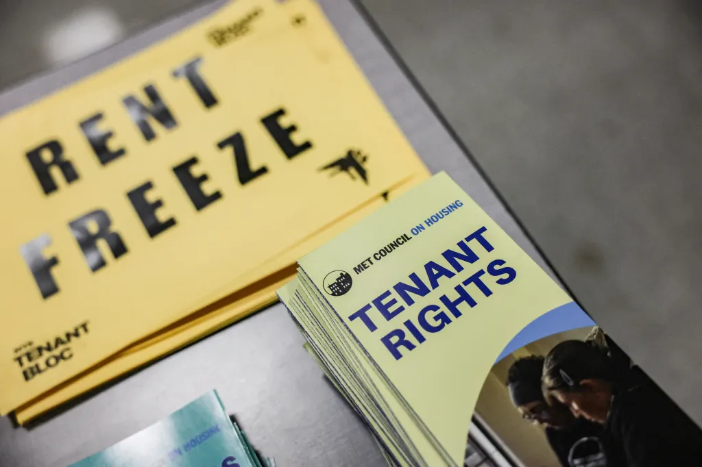 Pamphlets on tenant rights and materials calling for a rent freeze are displayed.
