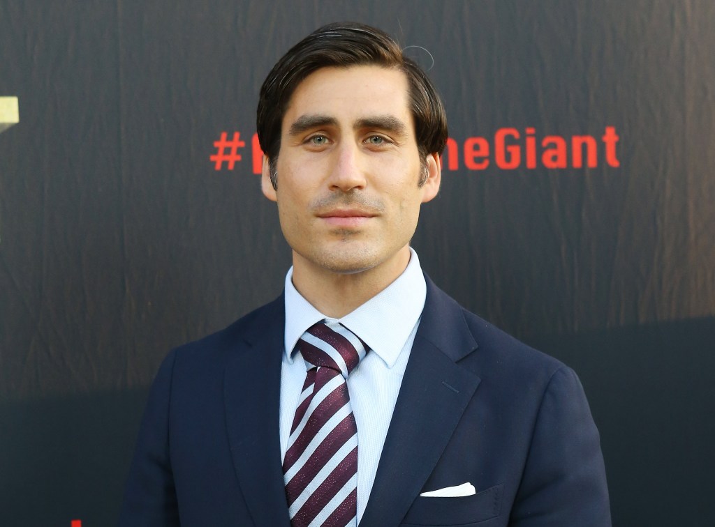 Peter Nelson, in a navy blue suit and maroon and blue striped tie and blue shirt, at the HBO World Premiere of