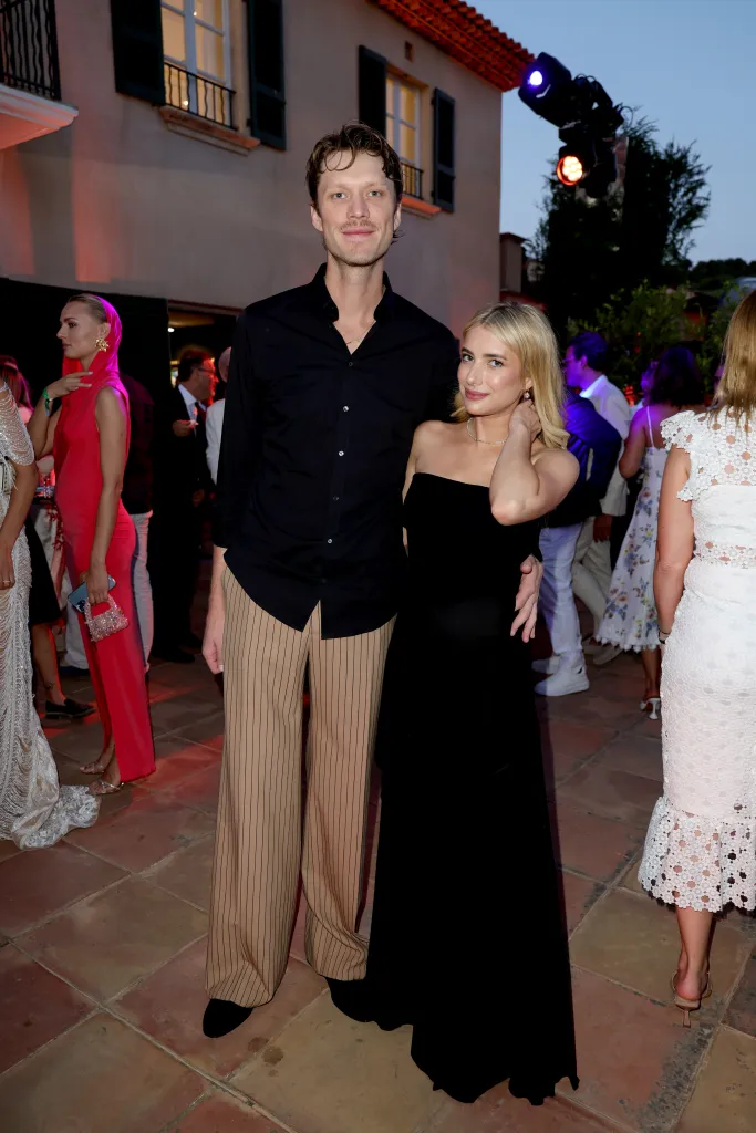 Cody John and Emma Roberts pose for a photo at a gala.