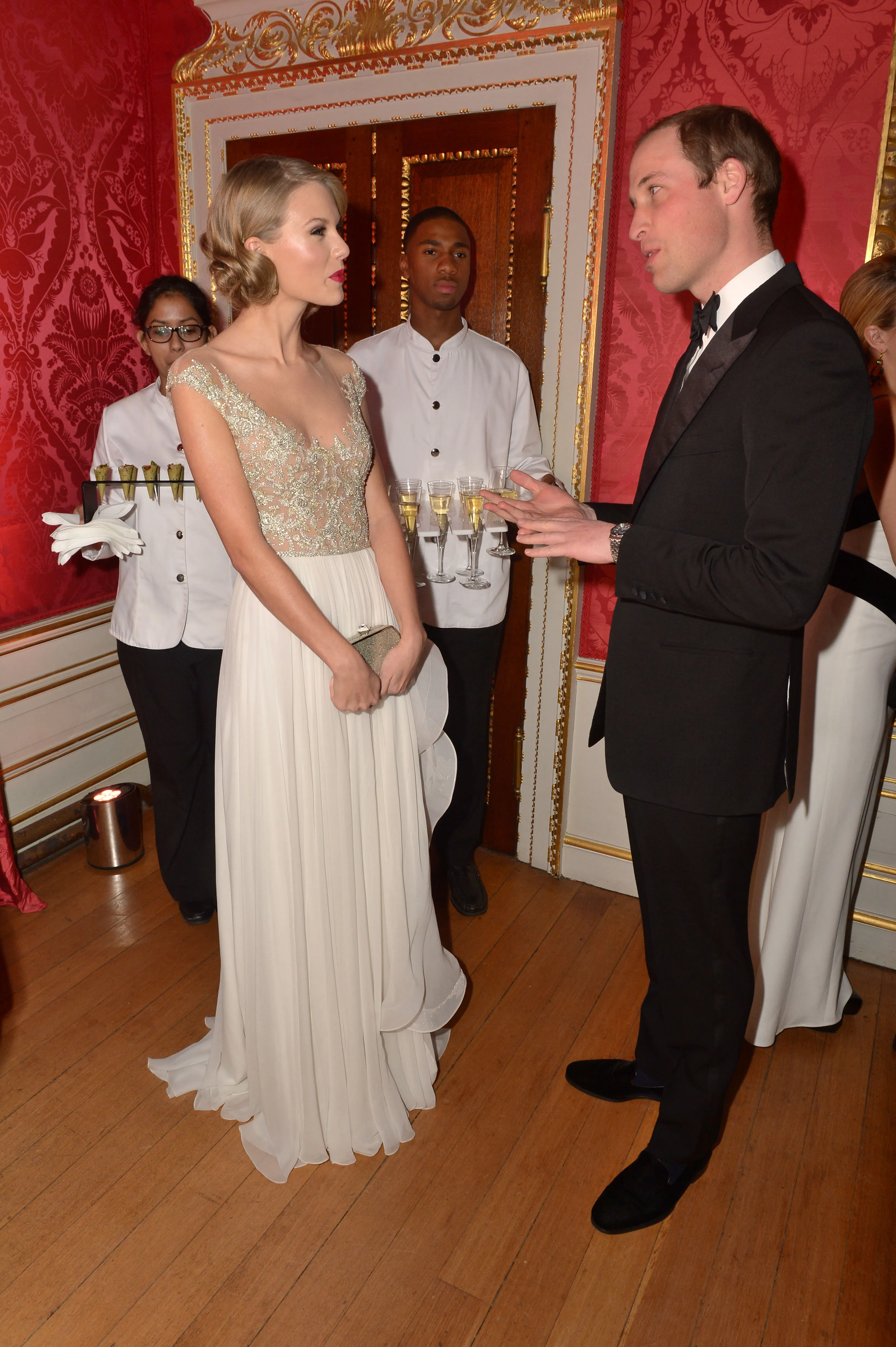Prince William and Taylor Swift talking at the Centrepoint Winter Whites Gala.