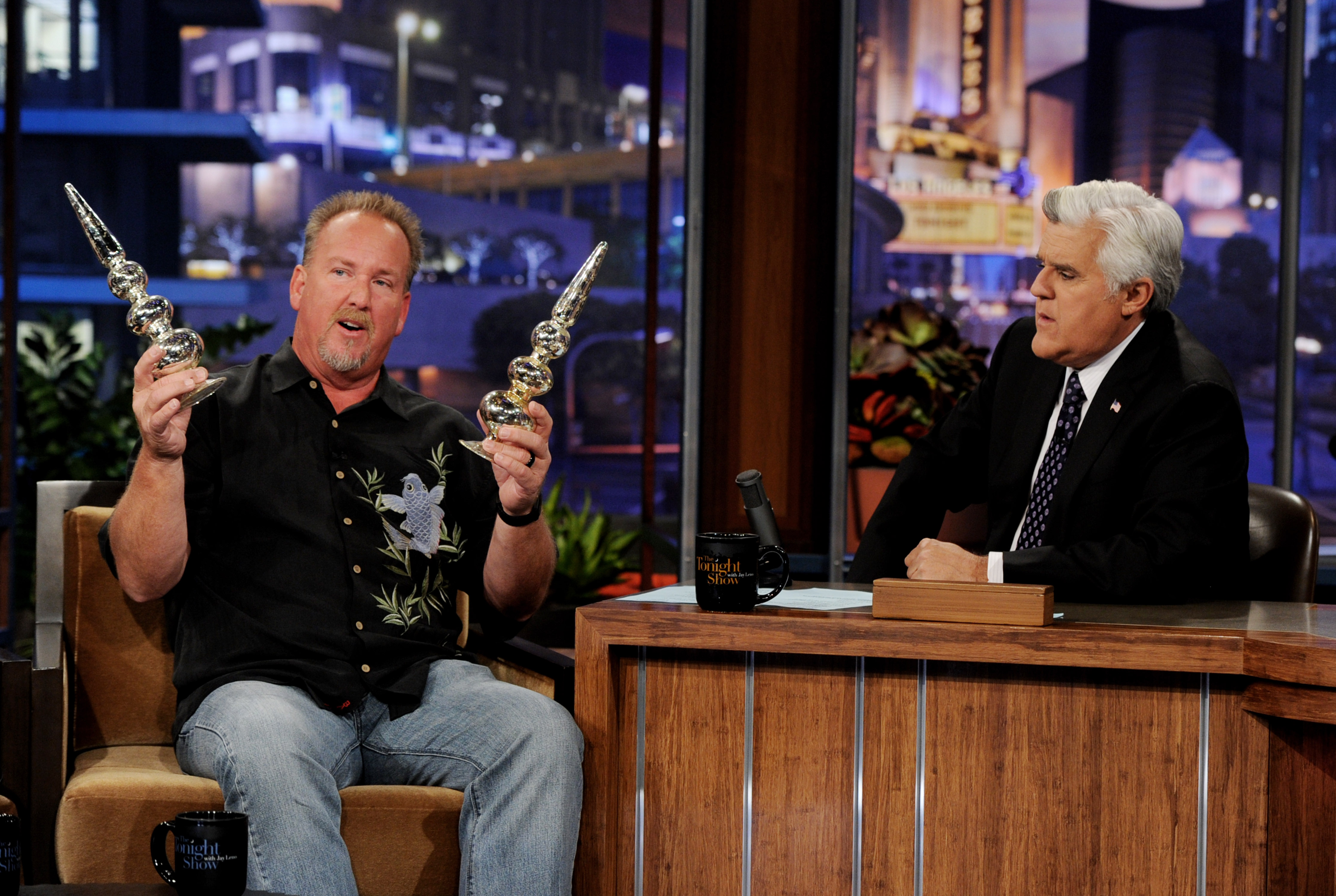 Darrell Sheets showing two silver finials to Jay Leno on 