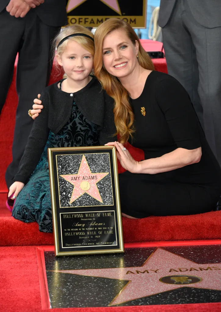 Amy Adams and her daughter Aviana Le Gallo smiling next to Adams' Hollywood Walk of Fame star and plaque.