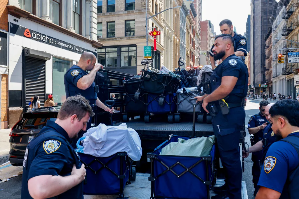 Police confiscate street vendors' merchandise in lower Manhattan.