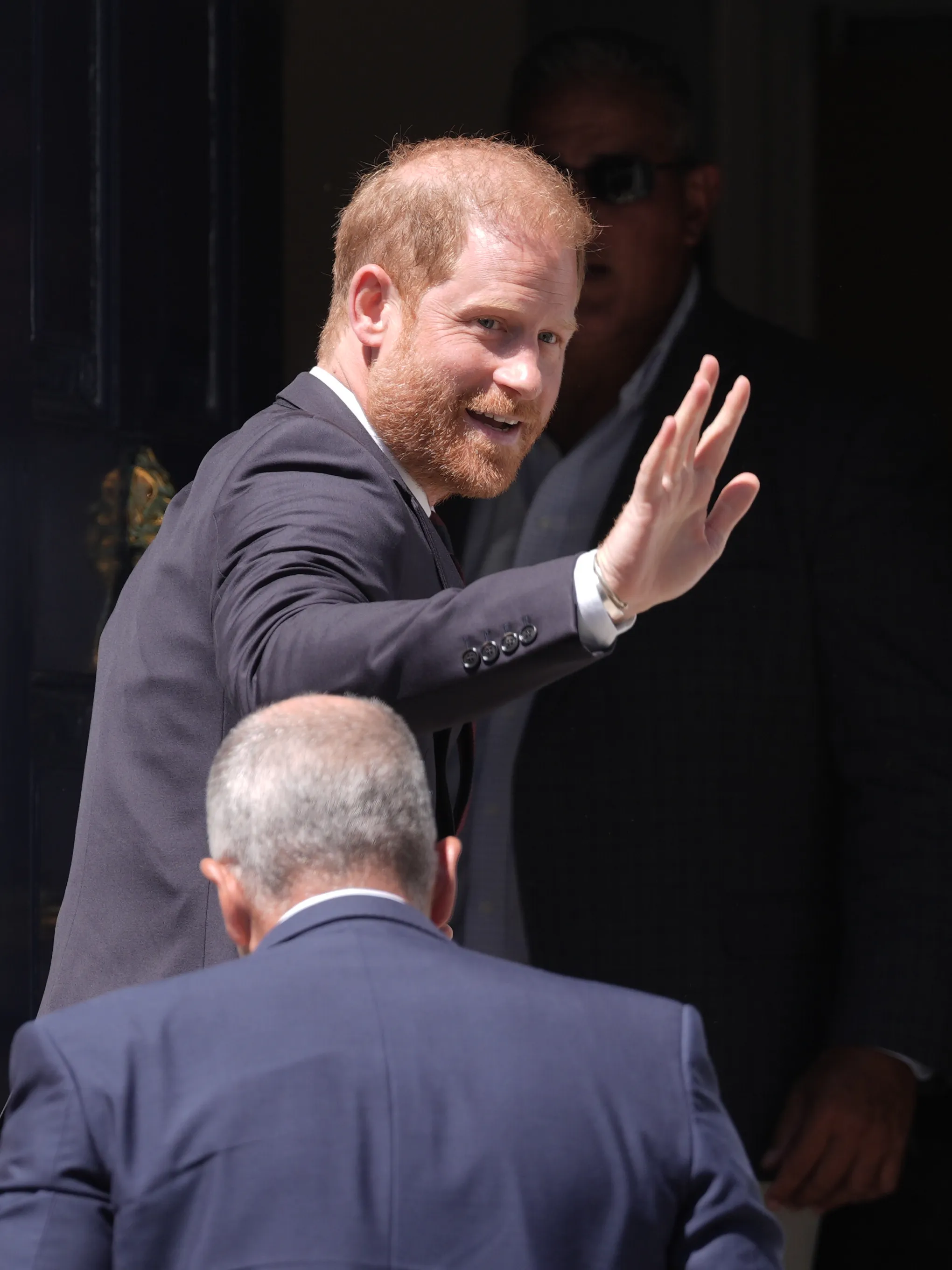 Prince Harry, Duke of Sussex, waving to people.