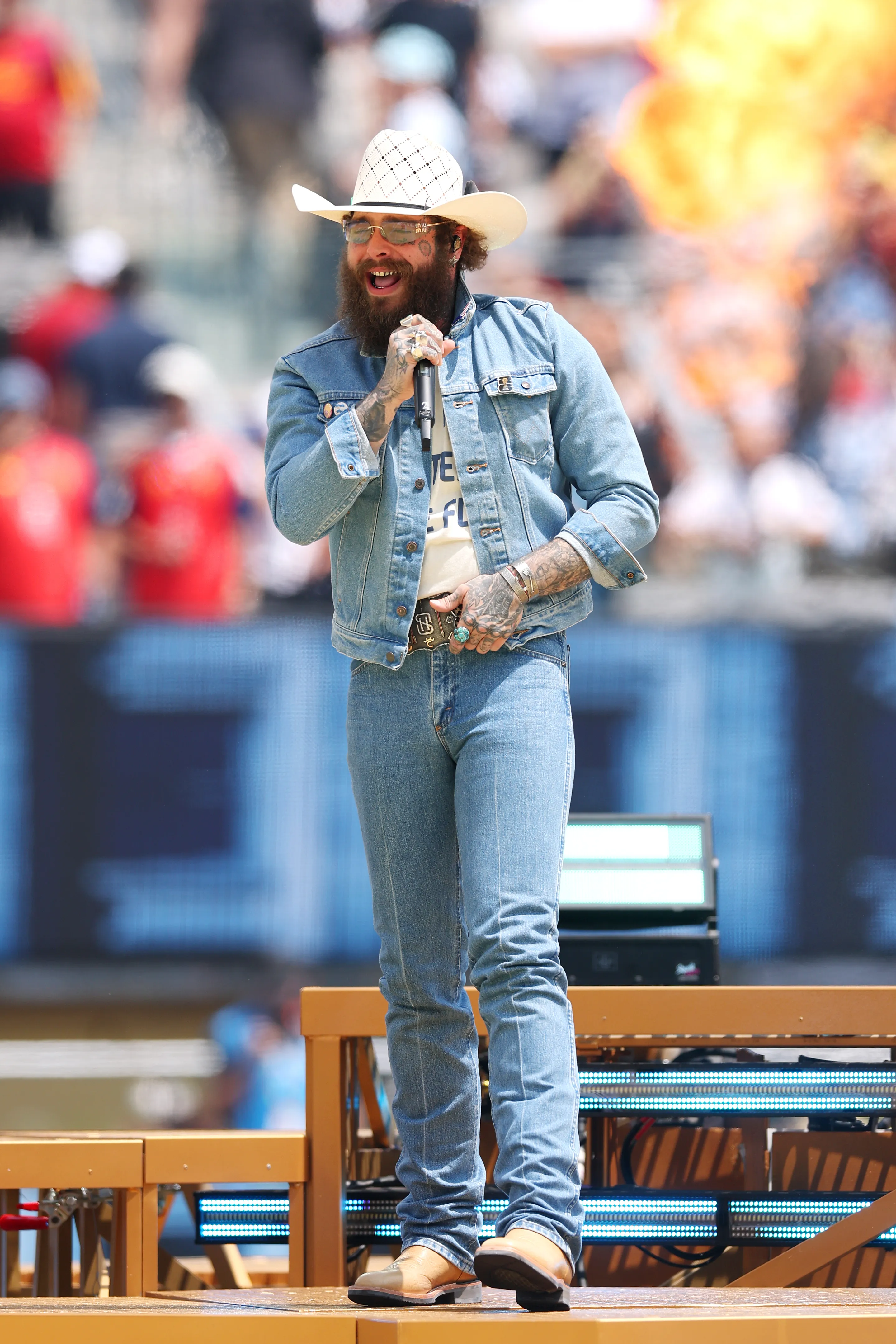 Post Malone performing at the FIFA World Cup 2026 Final wearing a white cowboy hat and denim.