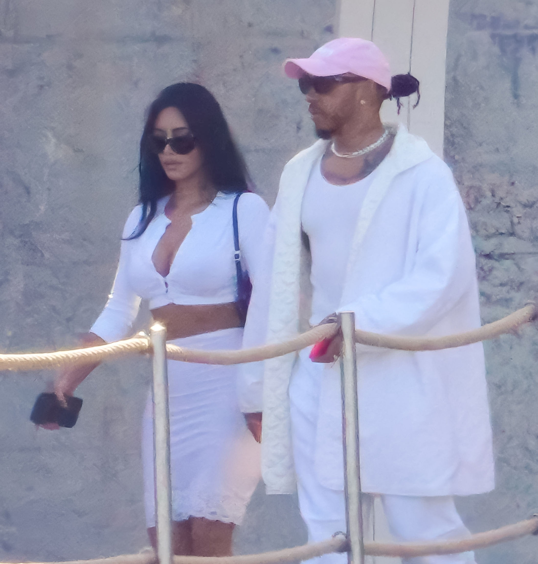 Kim Kardashian and Lewis Hamilton dressed in white, walking together in Monaco.
