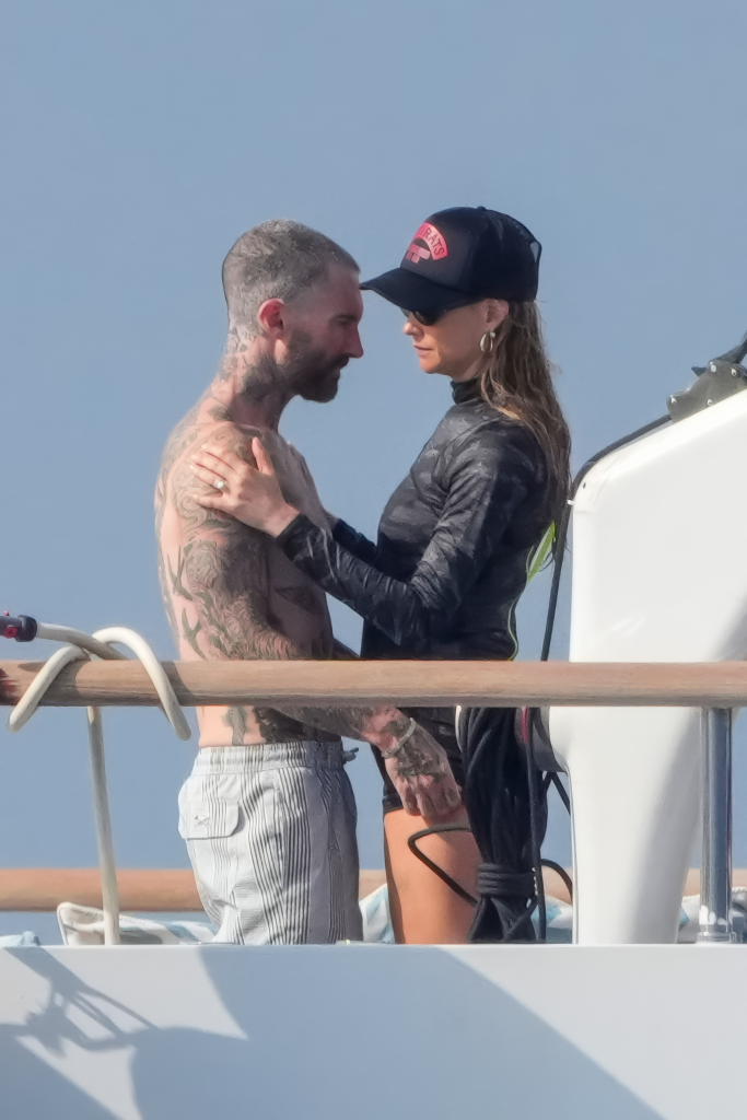 Adam Levine and Behati Prinsloo embrace on a luxury yacht.