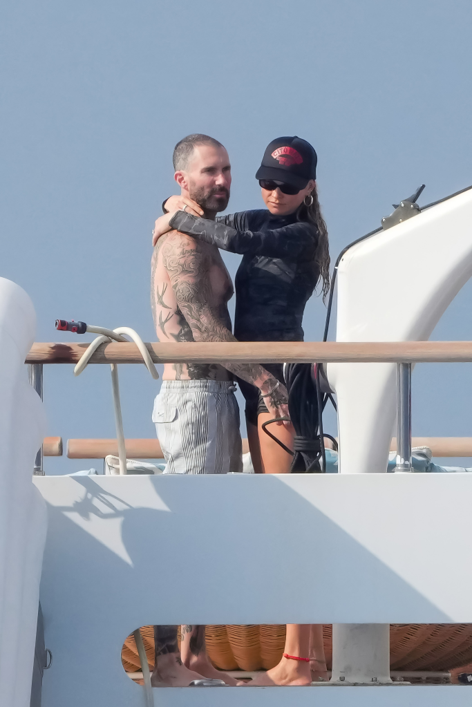 Adam Levine and Behati Prinsloo embracing on a luxury yacht.