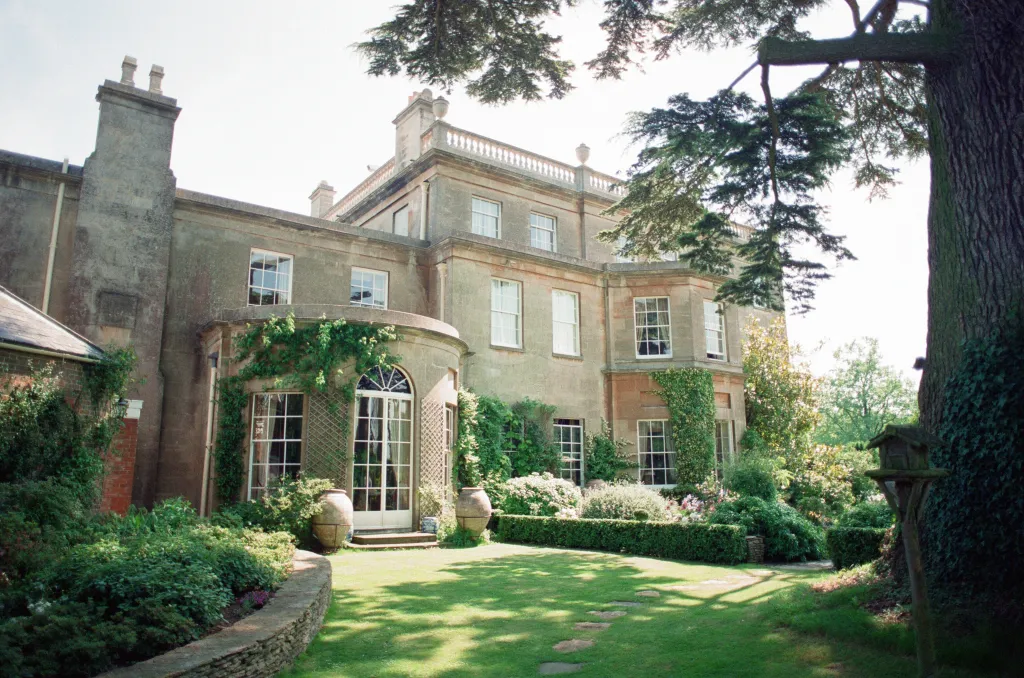 Highgrove House, Prince Charles's private residence, with a well-maintained garden and large trees.