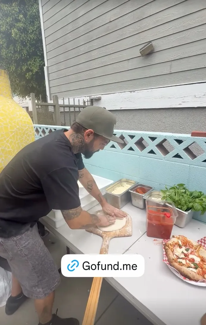 Navarone Garcia making pizza, with a