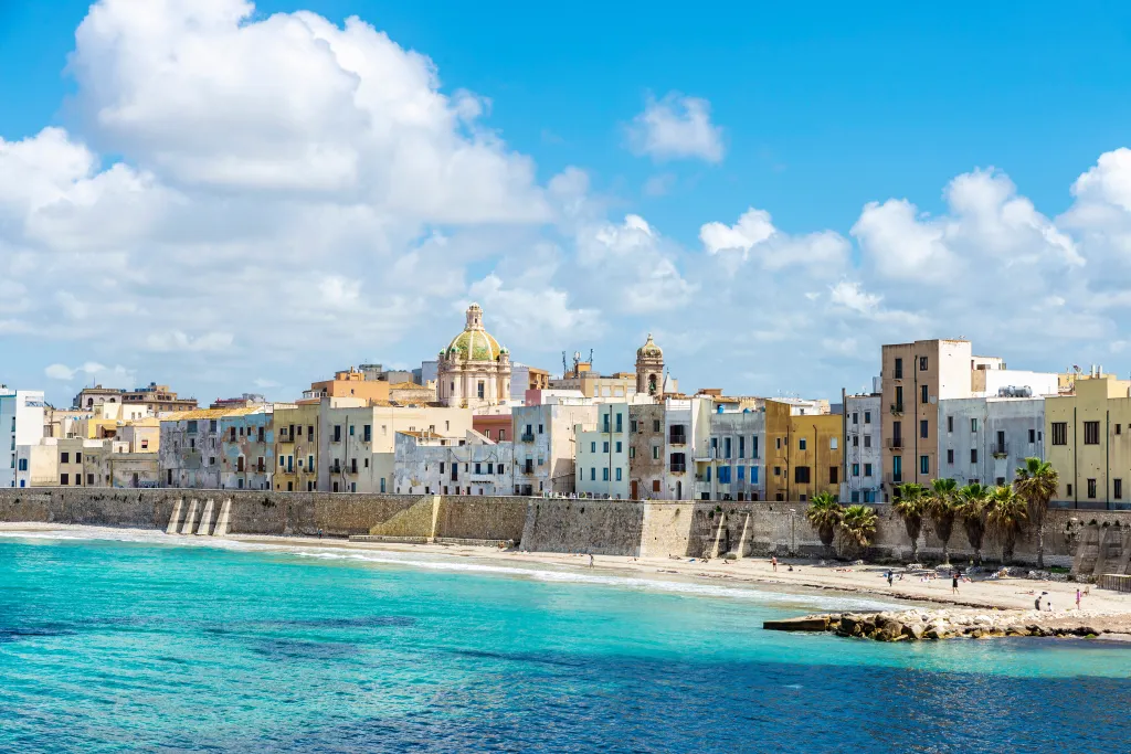 Promenade and beach with people around in the old town of Marsala, Trapani, Sicily, Italy.
