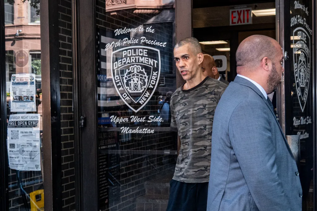 Raul Morales being escorted by cops.