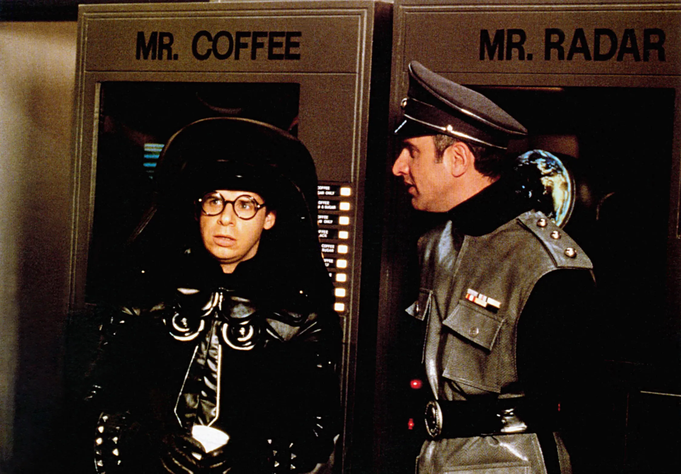 Rick Moranis as Lord Dark Helmet and George Wyner as a soldier stand near 