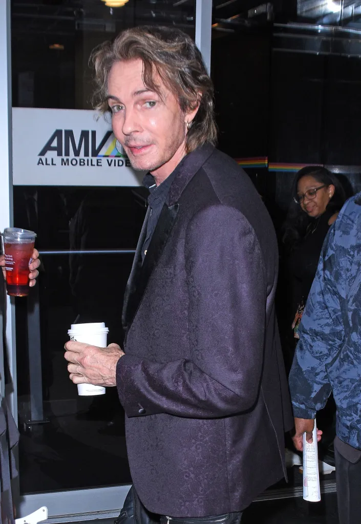 Rick Springfield holding a cup of coffee.