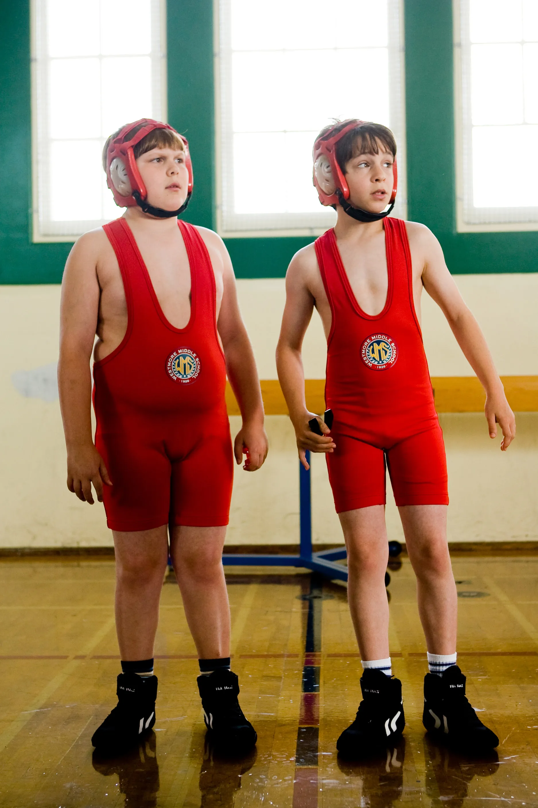 Robert Capron and Zachary Gordon in matching red wrestling uniforms and helmets.