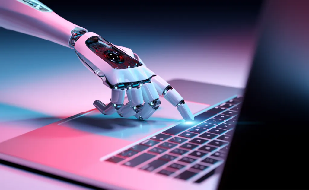Illustration of a robotic hand pressing a key on a laptop keyboard.