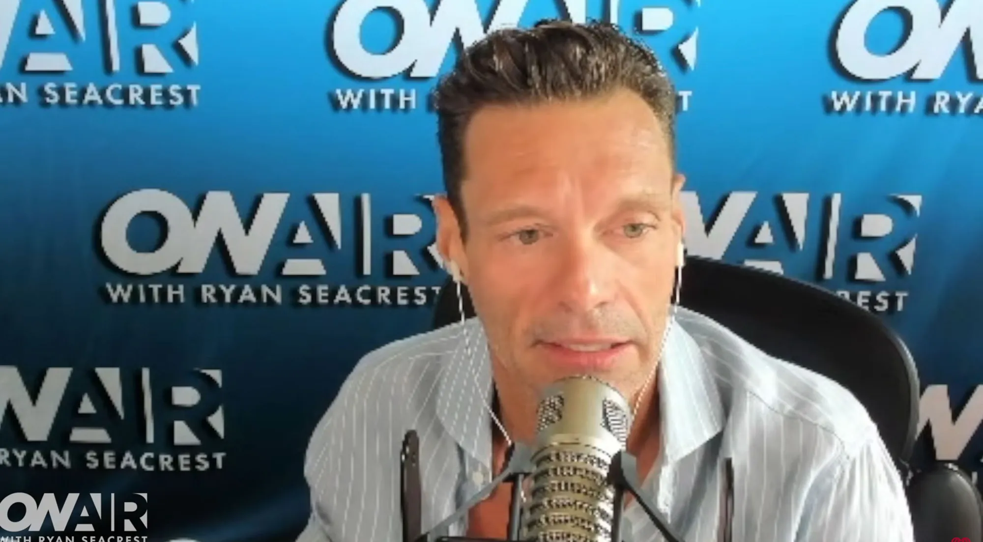 Ryan Seacrest speaking into a microphone.