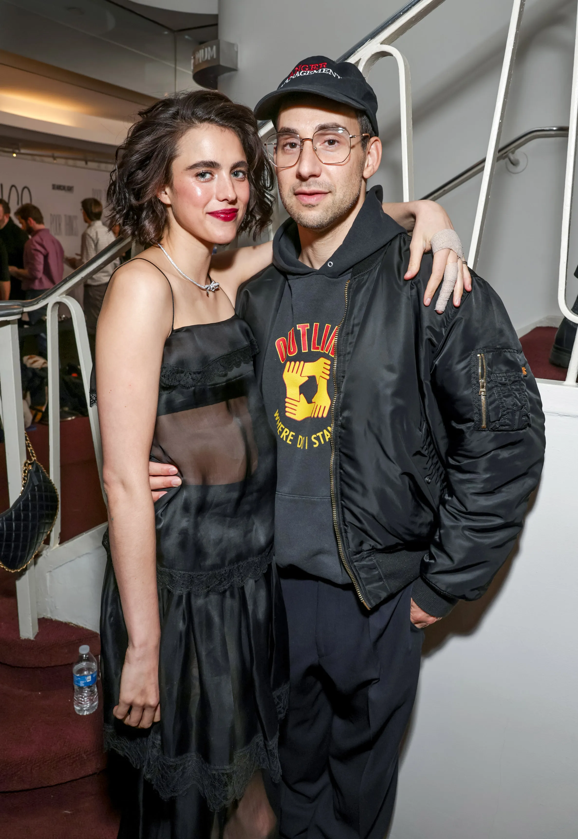 Sarah Margaret Qualley in a black dress and Jack Antonoff in a black bomber jacket.