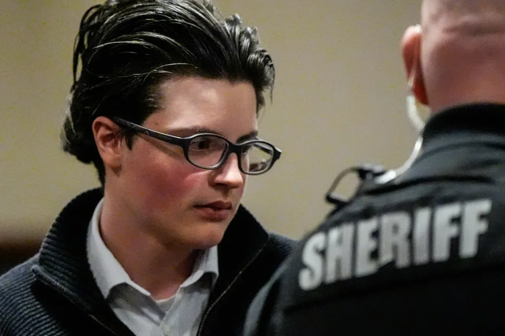 School shooting suspect Colt Gray looks at a sheriff.