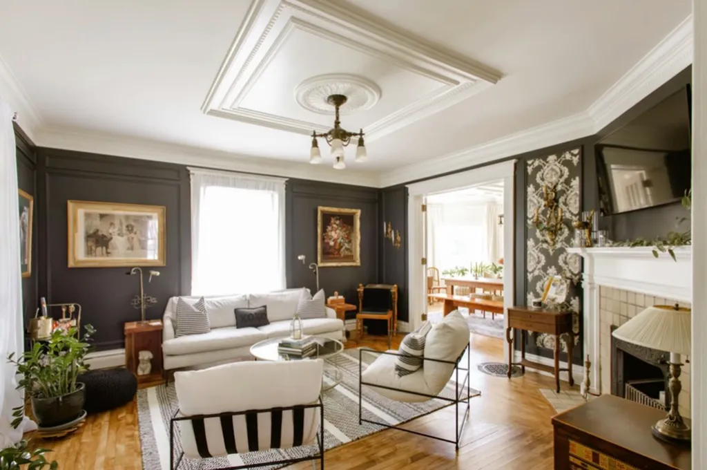 Living room of the Rose Manor Inn with dark gray walls and ornate white trim.