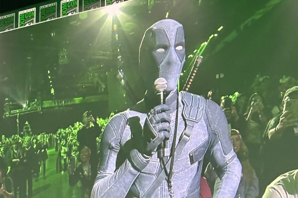 A person dressed as Deadpool speaking into a microphone.