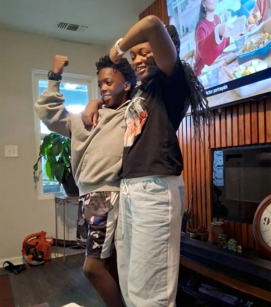 Seven (a black teen) and Lyric (black teen) standing together at home and smiling