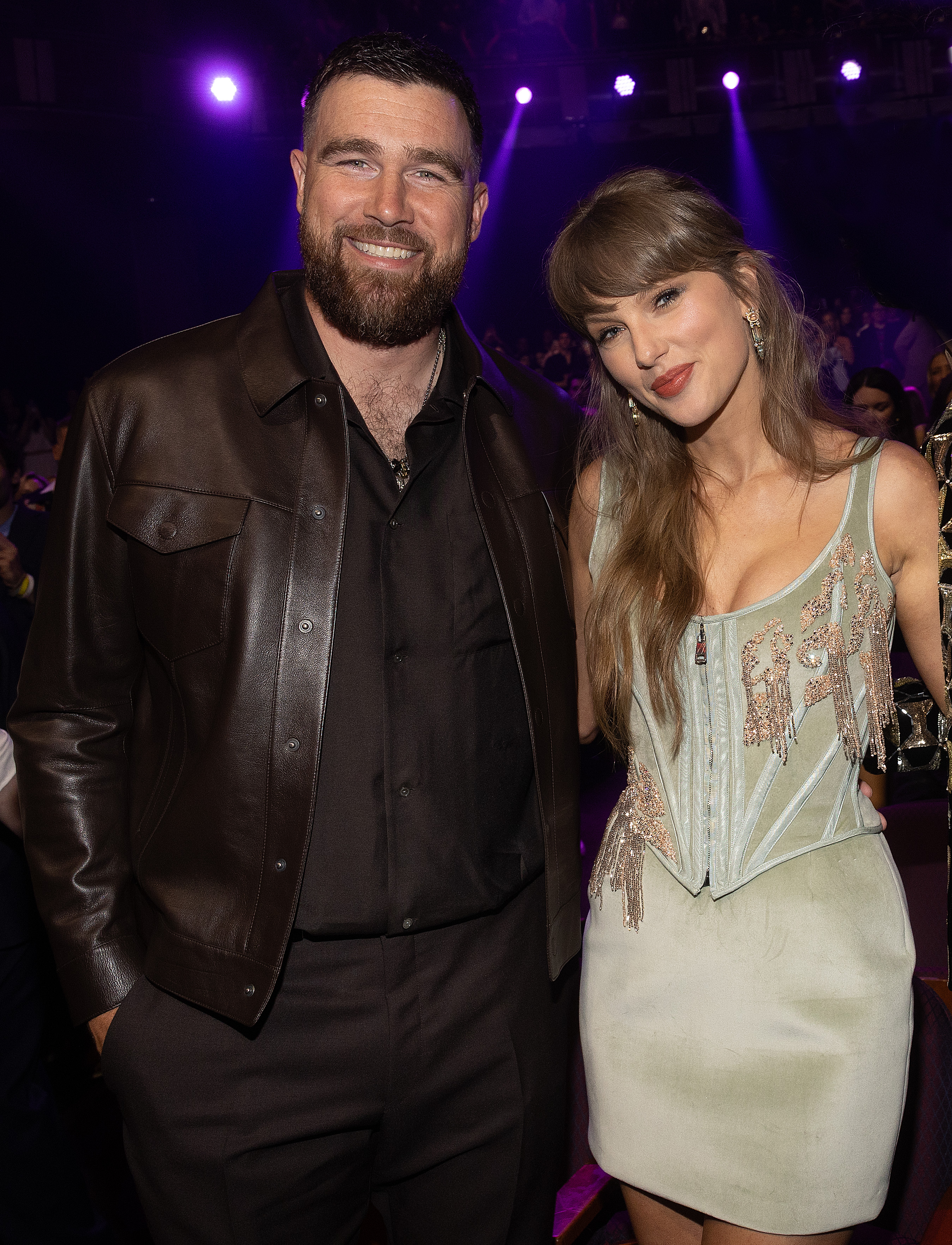 Travis Kelce and Taylor Swift smiling at an event.