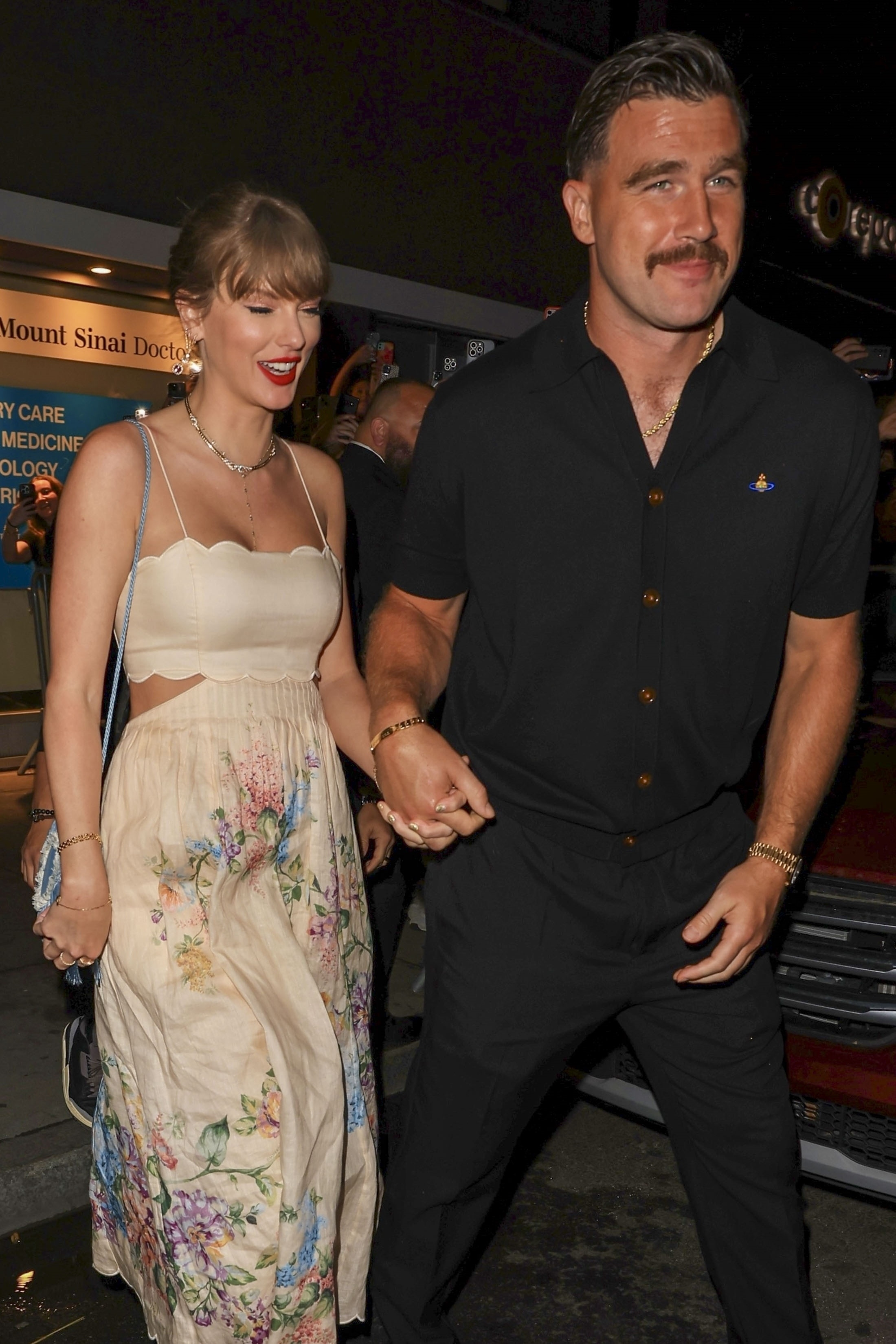 Taylor Swift and Travis Kelce leaving Electric Lady Studios in NYC, holding hands and smiling.