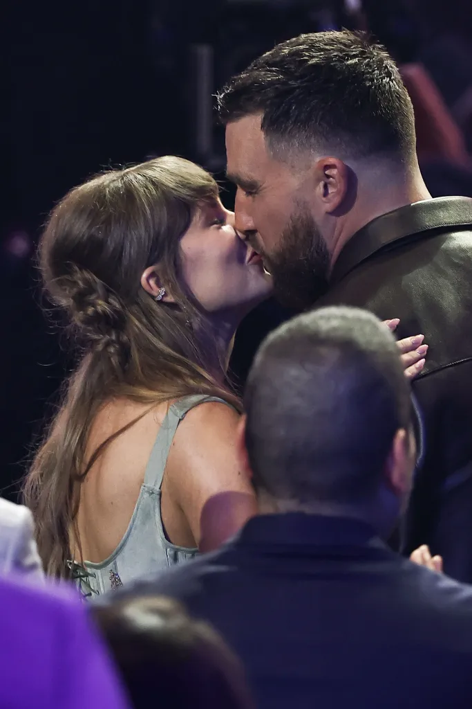 Taylor Swift kissing Travis Kelce.