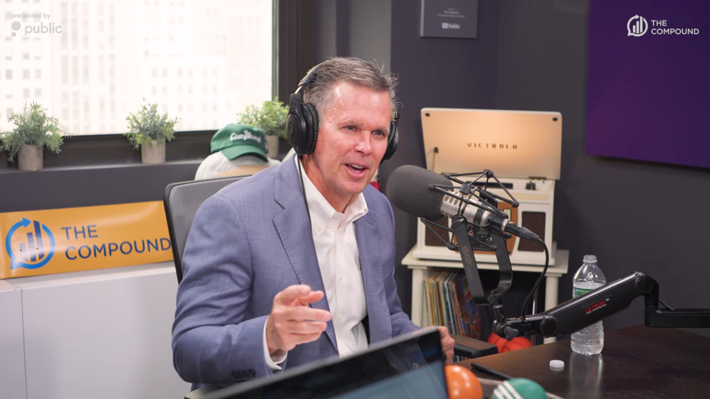 A man with headphones speaking into a microphone, with a