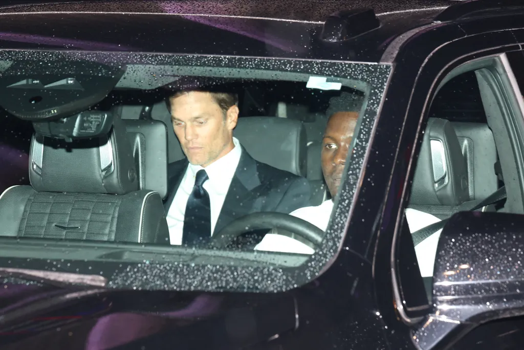 Tom Brady sits in a vehicle.