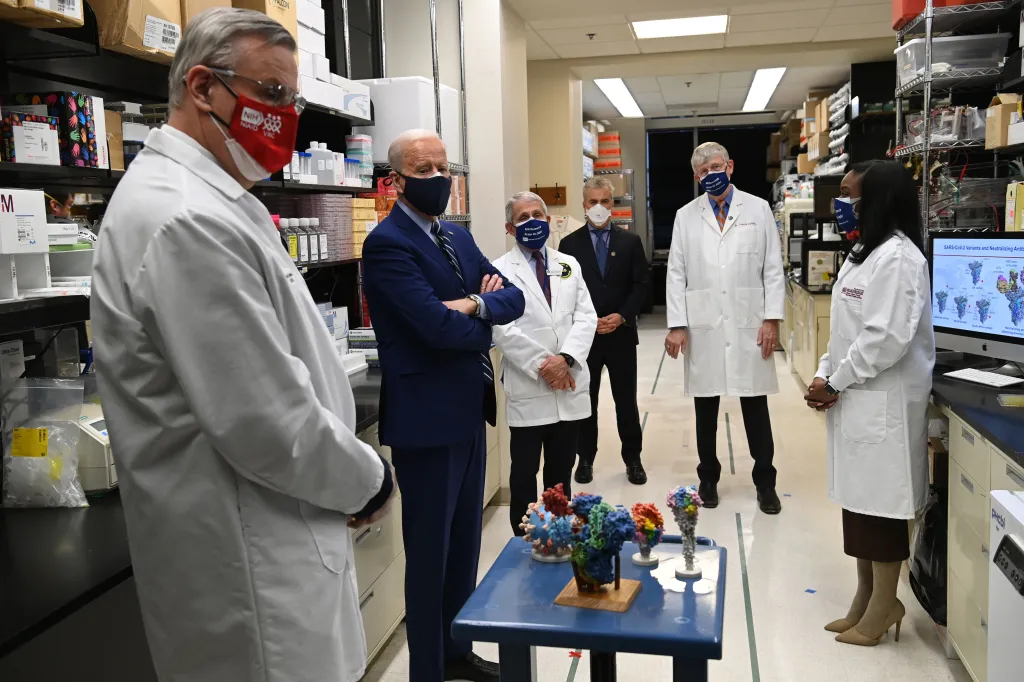 US President Joe Biden touring the Viral Pathogenesis Laboratory with Dr. Kizzmekia S. Corbett, Dr. Francis Collins, Jeffrey Zients, Dr. Anthony Fauci, and Dr. Barney S. Graham.