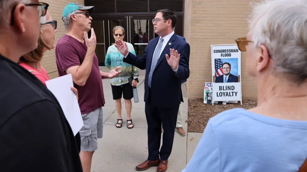 GOP lawmaker showered with boos  from angry town hall attendees for supporting Trump bill
