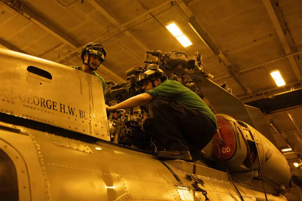 Sailors work on a MH-60S Sea Hawk helicopter aboard the USS George H.W. Bush.