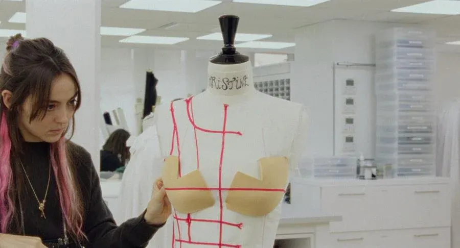 A seamstress (Garance Marillier) works on a dress in Couture . Source: Vertical