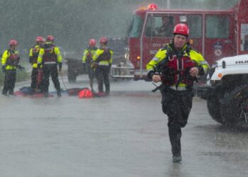 Texas flooding surges from huge rainstorms as rescuers pull people from rising waters