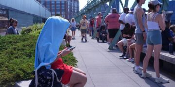 Searing heat and storms mar holiday with 3 children dead in Wisconsin and utility outages widespread