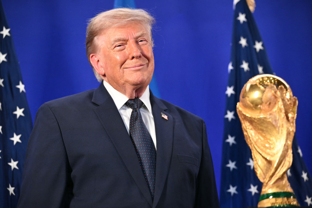 Donald Trump stands by the FIFA World Cup Trophy.
