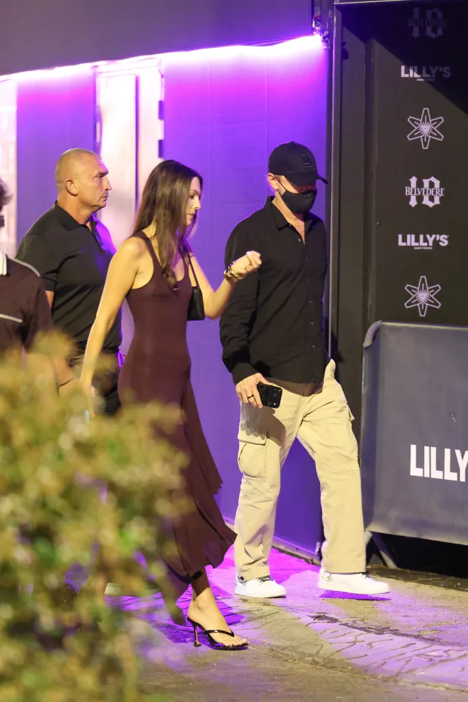 Leonardo DiCaprio and Vittoria Ceretti walking into Lilly's club.