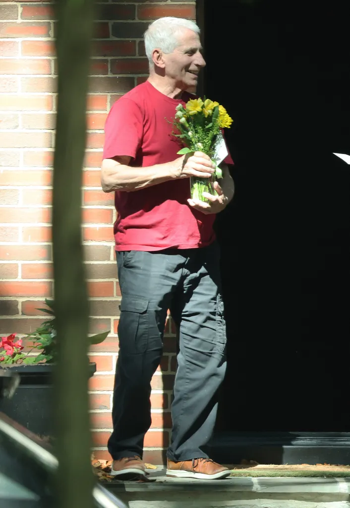 Dr. Anthony Fauci holding flowers.