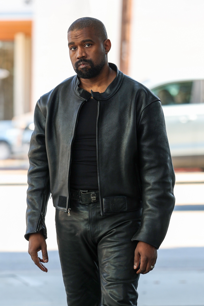 Kanye West in a black leather jacket and black leather pants.