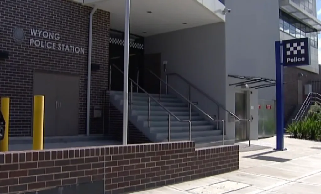 The exterior of the Wyong Police Station, with a brick facade and a blue 