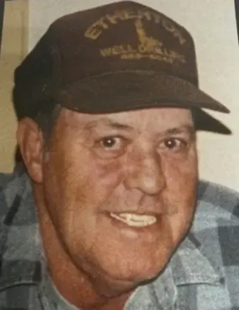 Coy Parton, brother of Dolly Parton, smiling while wearing a brown hat.