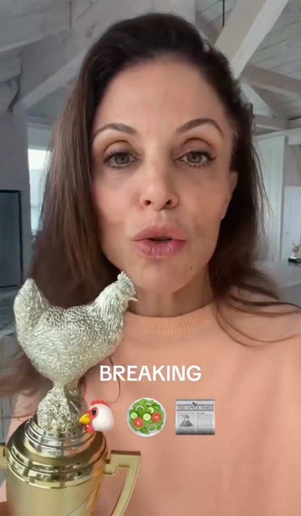 Bethenny Frankel holding a gold trophy topped with a silver chicken, with the word 