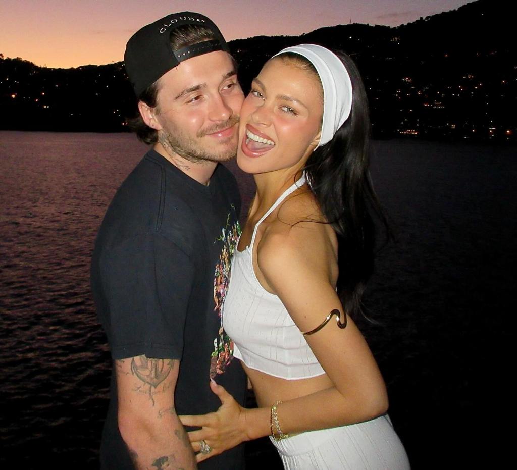 Nicola Peltz and Brooklyn Beckham embracing outdoors at night.