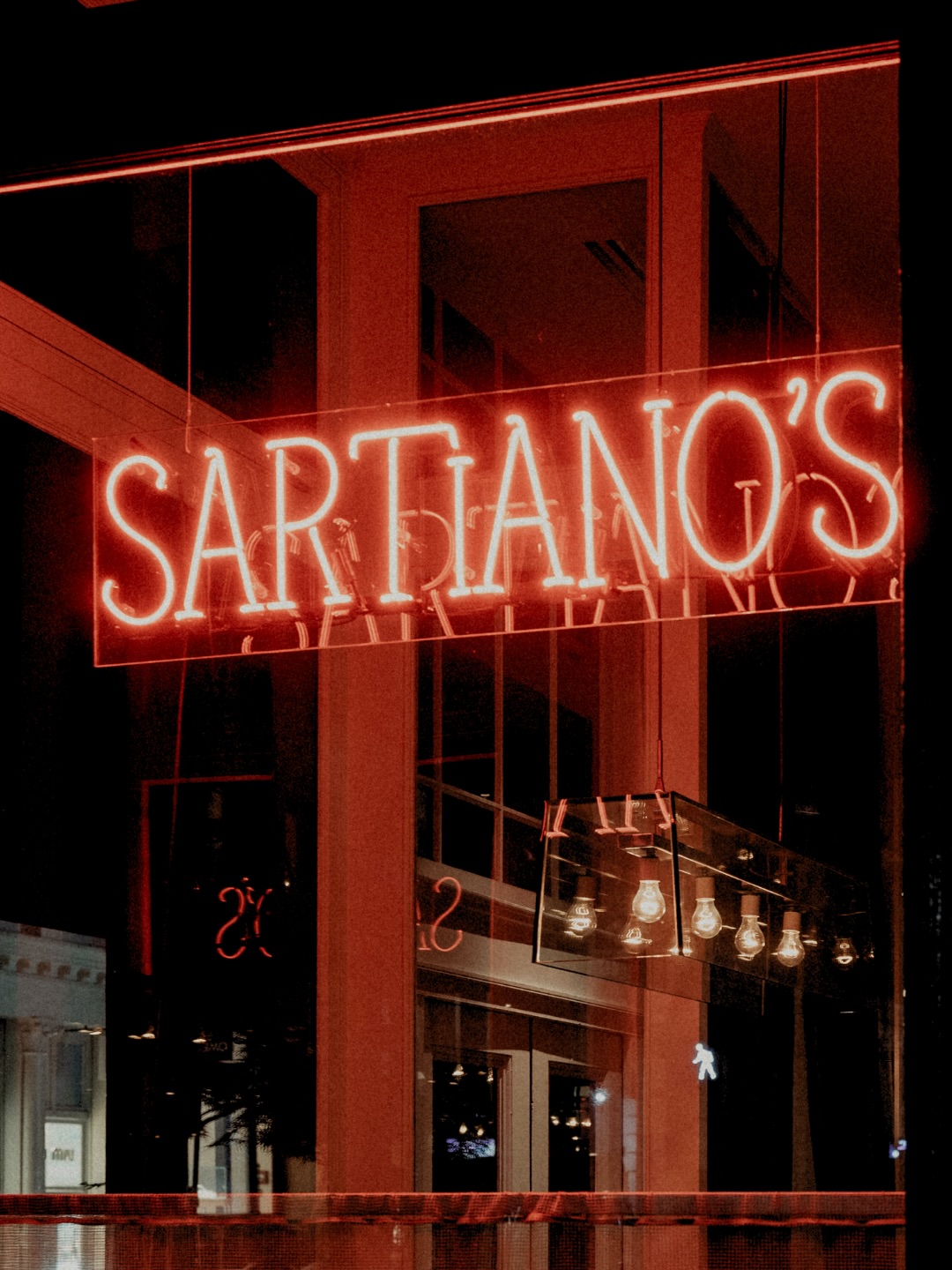 A glowing red neon sign for 