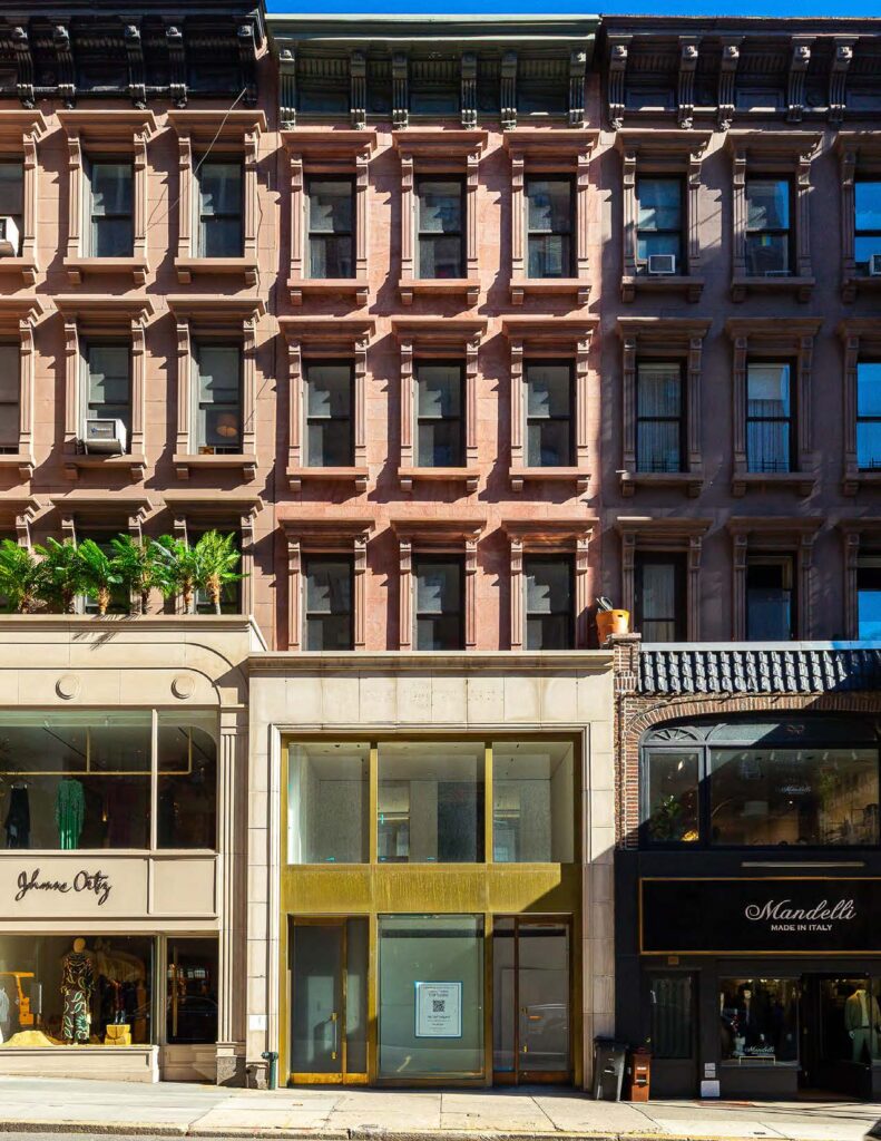 Exterior view of 797 Madison Avenue in New York City, featuring retail spaces on the ground floor and residential units above.