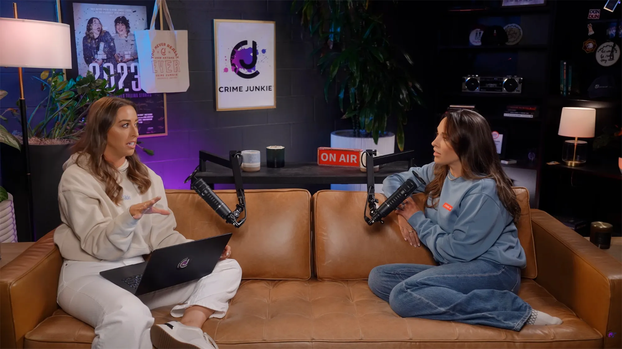 Two women recording the Crime Junkie podcast with 