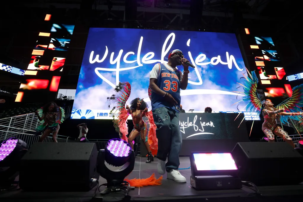 Wyclef Jean performs on stage in a